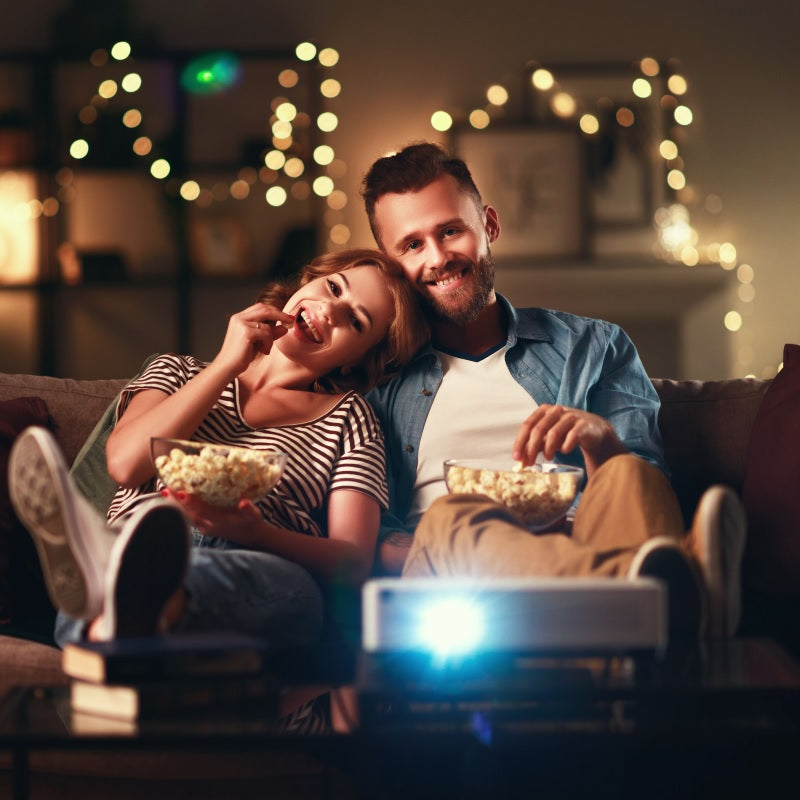 Couple enjoying premium snacks on a sofa